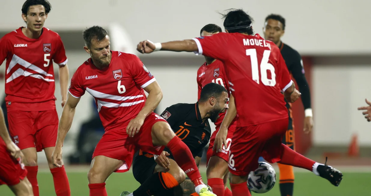 epa09107606 Scott Wiseman (2-L) of Gibraltar, in action against Memphis Depay (C) of the Netherlands during the FIFA World Cup 2022 qualifiers match between Gibraltar and the Netherlands at the Victoria Stadium in Gibraltar, 30 March 2021. EPA/KOEN VAN WEEL