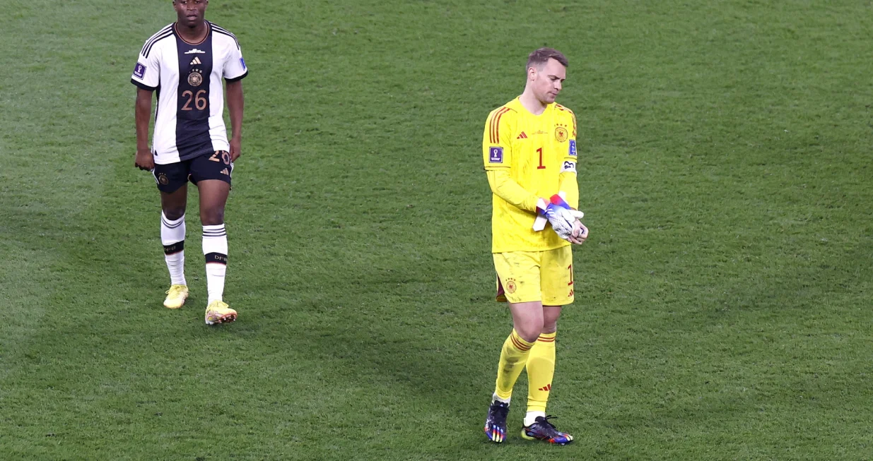 epa10322835 Goalkeeper Manuel Neuer (R) of Germany and teammate Youssoufa Moukoko walk off the pitch after the FIFA World Cup 2022 group E soccer match between Germany and Japan at Khalifa International Stadium in Doha, Qatar, 23 November 2022. EPA/Rungroj Yongrit