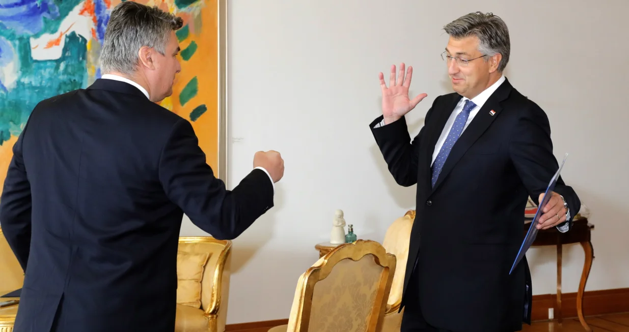 epa08549484 Croatian President Zoran Milanovic (L) gives a mandate for new Government and new Prime Minister to Andrej Plenkovic (R), after his Croatian Democratic Union (HDZ) won the Parliamentary elections during their first official meeting in Zagreb, Croatiua, 16 July 2020. After Andrej Plenkovic will still need 76 votes to establish new Government. EPA/ANTONIO BAT/Antonio Bat