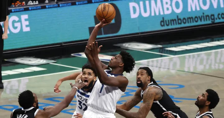 epa09105745 Minnesota Timberwolves forward Anthony Edwards (C) looks to put up a shot past the Brooklyn Nets defense in the second half of the NBA basketball game between the Minnesota Timberwolves and the Brooklyn Nets at the Barclays Center in Brooklyn, New York, USA, 29 March 2021. EPA/JASON SZENES SHUTTERSTOCK OUT