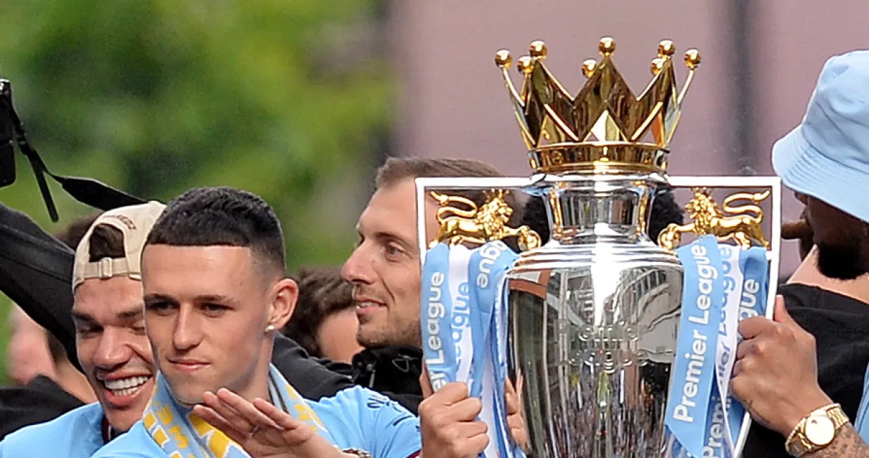 epa09970571 Manchester City's Phil Foden with the Premier League trophy during the celebrations of the Manchester City team winning the English Premier League title, Manchester, Britain, 23 May 2022. Manchester City won the 2021-22 season with 93 points, their fourth league title in five seasons. EPA/PETER POWELL/Peter Powell