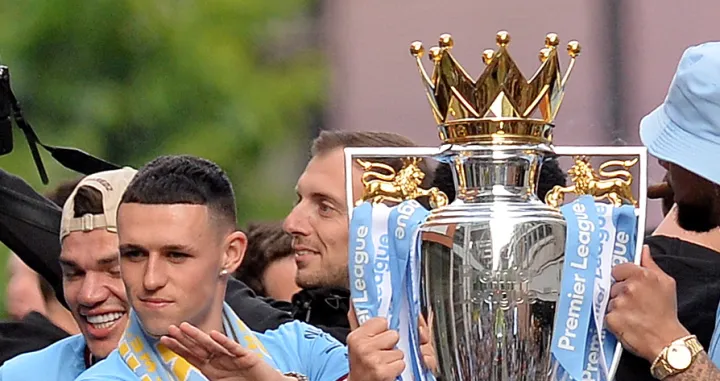 epa09970571 Manchester City's Phil Foden with the Premier League trophy during the celebrations of the Manchester City team winning the English Premier League title, Manchester, Britain, 23 May 2022. Manchester City won the 2021-22 season with 93 points, their fourth league title in five seasons. EPA/PETER POWELL/Peter Powell