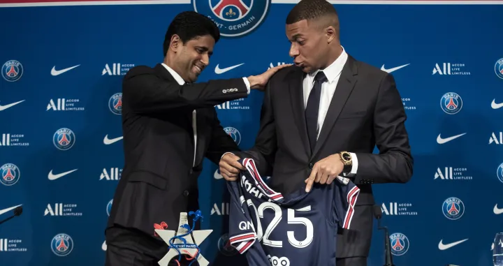 epa09969927 Paris Saint-Germain's president Nasser Al-Khelaifi (L) and Paris Saint Germain's forward Kylian Mbappe attend a press conference at the Parc des Princes stadium in Paris, France, 23 May 2022. Kylian Mbappe renewed his contract with French Ligue 1 soccer club Paris Saint-Germain until 2025. EPA/Christophe Petit Tesson