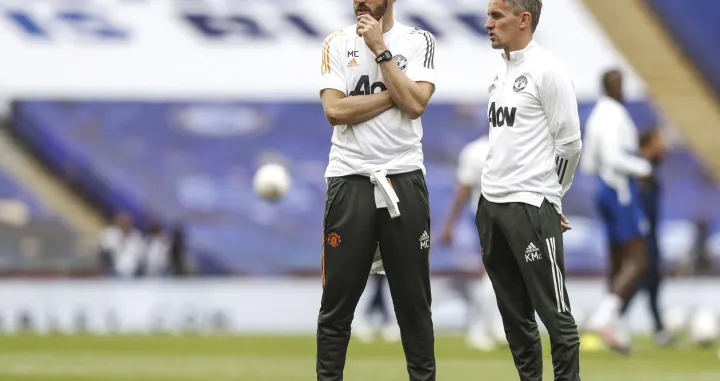 epa08555155 Manchester United's English first-team coach Michael Carrick (L) speaks with Manchester United's Northern Irish first-team coach Kieran McKenna prior to the English FA Cup semi final match between Manchester United and Chelsea FC at the Wembley stadium in London, Britain, 19 July 2020. EPA/Alastair Grant/NMC/Pool EDITORIAL USE ONLY. No use with unauthorized audio, video, data, fixture lists, club/league logos or 'live' services. Online in-match use limited to 120 images, no video emulation. No use in betting, games or single club/league/player publications.