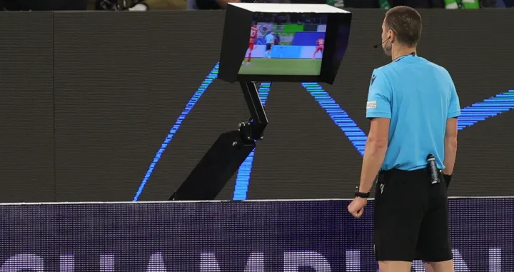 epa09496436 Referee Georgi Kabakov checks the VAR replay during the UEFA Champions League group G soccer match between VfL Wolfsburg and Sevilla FC in Wolfsburg, Germany, 29 September 2021. EPA/Friedemann Vogel