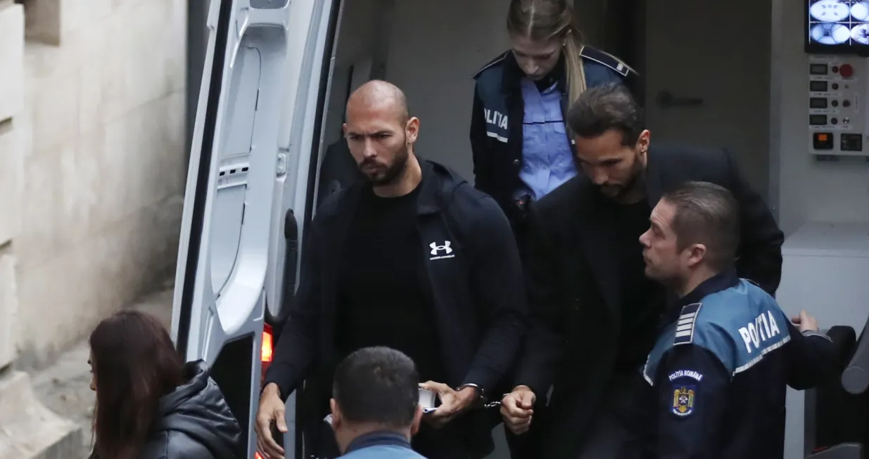 epa10397705 Former professional kickboxer and social media influencer, American-British businessman Andrew Tate (C), and his brother Tristan Tate are escorted by Romanian police officers inside the Court of Appeal building for a hearing in their trial in Bucharest, Romania, 10 January 2023. On 29 December 2022, Andrew and Tristan Tate were arrested as a result of Directorate for Investigating Organized Crime and Terrorism (DIICOT) division inquiry under the charges of human trafficking and the intention of forming an organized crime group. Romanian police stated that the two brothers and their associates coerced victims for creating a paid pornography service for social media platforms. A Romanian judge ordered on 30 December 2022 that Andrew Tate shall remain in police custody for 30 days, as criminal police investigation is ongoing. In total, 11 cars and ten buildings located near Bucharest, or in Ilfov and Prahova counties, owned by the Tate brothers, were seized by the Romanian authorities until the inquiry will be finished. EPA/Robert Ghement/Robert Ghement