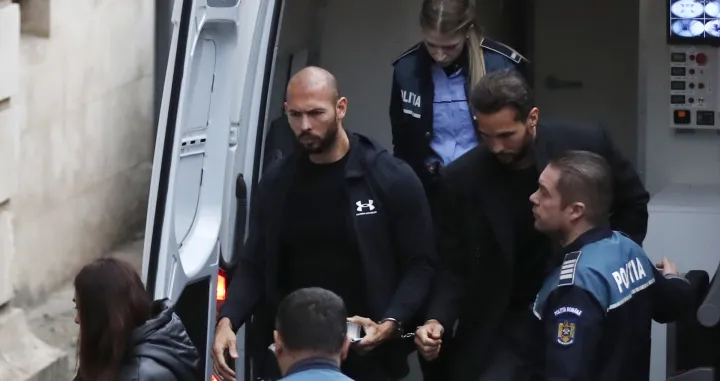 epa10397705 Former professional kickboxer and social media influencer, American-British businessman Andrew Tate (C), and his brother Tristan Tate are escorted by Romanian police officers inside the Court of Appeal building for a hearing in their trial in Bucharest, Romania, 10 January 2023. On 29 December 2022, Andrew and Tristan Tate were arrested as a result of Directorate for Investigating Organized Crime and Terrorism (DIICOT) division inquiry under the charges of human trafficking and the intention of forming an organized crime group. Romanian police stated that the two brothers and their associates coerced victims for creating a paid pornography service for social media platforms. A Romanian judge ordered on 30 December 2022 that Andrew Tate shall remain in police custody for 30 days, as criminal police investigation is ongoing. In total, 11 cars and ten buildings located near Bucharest, or in Ilfov and Prahova counties, owned by the Tate brothers, were seized by the Romanian authorities until the inquiry will be finished. EPA/Robert Ghement/Robert Ghement