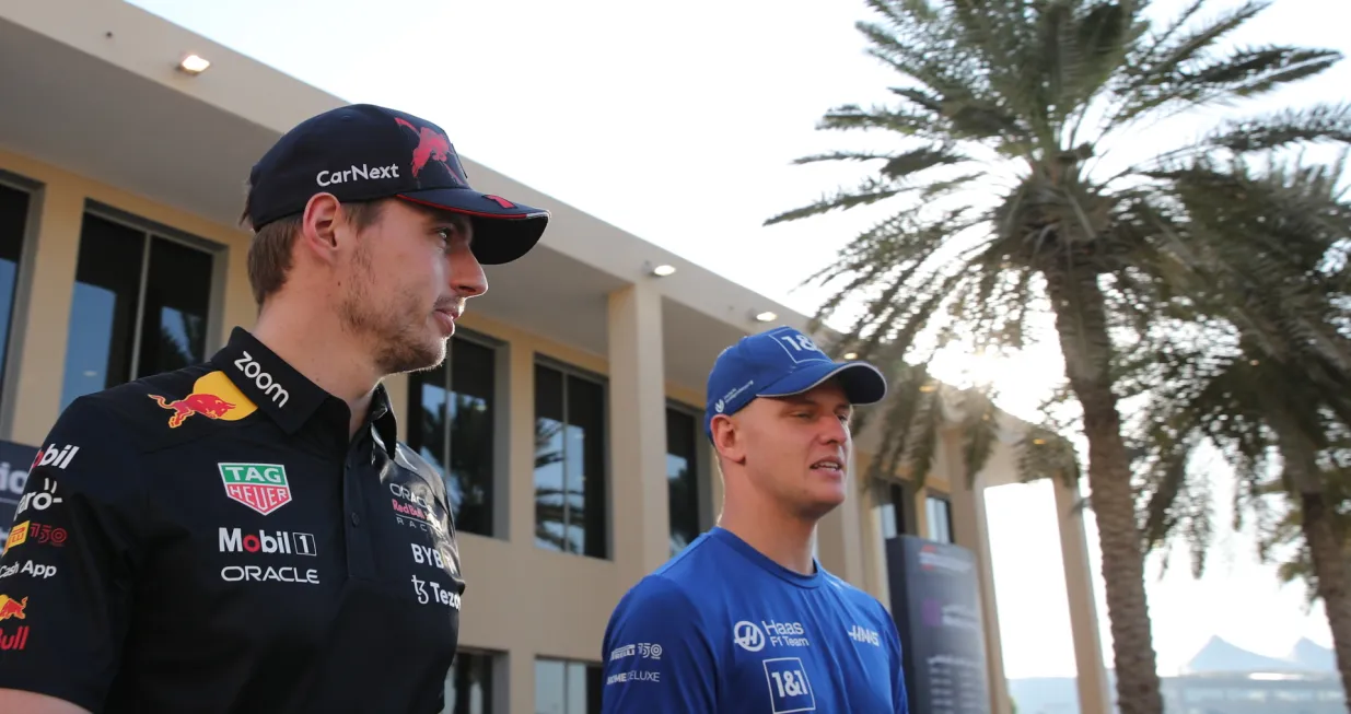 epa10310382 Dutch Formula One driver Max Verstappen (L) of Red Bull Racing and German driver Mick Schumacher (R) of the Haas F1 Team walk through the paddock ahead of the Abu Dhabi Formula One Grand Prix 2022 at Yas Marina Circuit in Abu Dhabi, United Arab Emirates, 17 November 2022. The Formula One Grand Prix of Abu Dhabi will take place on 20 November 2022. EPA/ALI HAIDER