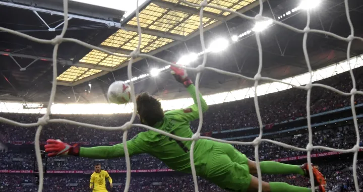 epa09947475 Goalkepeer Alisson of Liverpool saves a penalty against Mason Mount (L) of Chelsea during the English FA Cup final between Chelsea FC and Liverpool FC at Wembley in London, Britain, 14 May 2022. EPA/NEIL HALL EDITORIAL USE ONLY. No use with unauthorized audio, video, data, fixture lists, club/league logos or 'live' services. Online in-match use limited to 120 images, no video emulation. No use in betting, games or single club/league/player publications