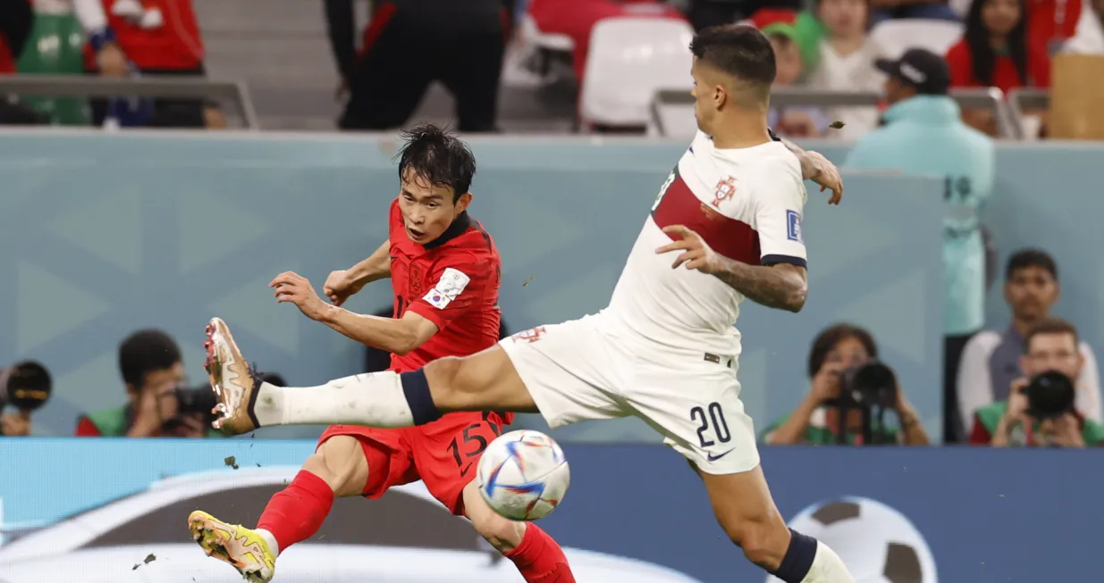 epa10344548 Moonhwan Kim of South Korea in action against Joao Cancelo of Portugal during the FIFA World Cup 2022 group H soccer match between South Korea and Portugal at Education City Stadium in Doha, Qatar, 02 December 2022. EPA/Rungroj Yongrit