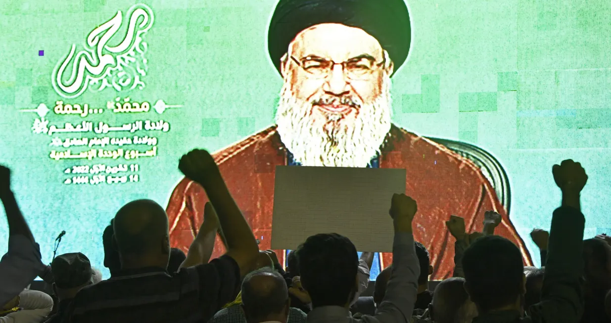 epa10237163 Hezbollah supporters react as they listen to Hezbollah leader Hassan Nasrallah deliver a speech on a screen, in the southern suburbs of Beirut, Lebanon, 11 October 2022. Nasrallah encouraged Lebanese resistance fighters on the occasion of the birth of the Prophet Muhammad. EPA/WAEL HAMZEH/Wael Hamzeh