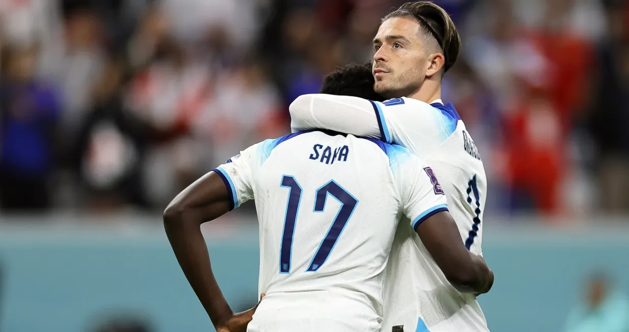 epa10360362 England players Bukayo Saka (L) and Jack Grealish (R) react after losing the FIFA World Cup 2022 quarter final soccer match between England and France at Al Bayt Stadium in Al Khor, Qatar, 10 December 2022. EPA/Ronald Wittek