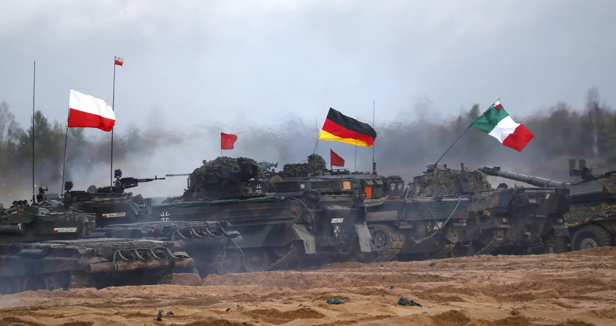 epa10307273 Polish (L), German and Italian (R) servicemen with their armoured vehicles attend the fire training during the military exercise 'Iron Spear', in Adazi military base, Latvia, 15 November 2022. Exercise Iron Spear demonstrates NATO firepower and interoperability. Some 34 teams from 13 NATO nations participate in a competition featuring both main battle tanks and infantry fighting vehicles. The NATO enhanced Forward Presence Battle Group (eFP BG) Latvia is conducting the exercise along with Allies from the multinational eFP BGs in Estonia, Lithuania and Poland as well as the Latvian Land Forces Mechanized Infantry Brigade and the Danish First Battalion-Royal Lifeguards. The teams competing in exercise are from Belgium, Denmark, Estonia, Germany, Italy, Latvia, Norway, Poland, Slovakia, Spain, the United Kingdom and the United States with support from the eFP BG Latvia Framework Nation of Canada. EPA/TOMS KALNINS/Toms Kalnins