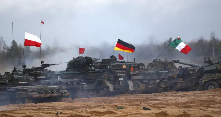 epa10307273 Polish (L), German and Italian (R) servicemen with their armoured vehicles attend the fire training during the military exercise 'Iron Spear', in Adazi military base, Latvia, 15 November 2022. Exercise Iron Spear demonstrates NATO firepower and interoperability. Some 34 teams from 13 NATO nations participate in a competition featuring both main battle tanks and infantry fighting vehicles. The NATO enhanced Forward Presence Battle Group (eFP BG) Latvia is conducting the exercise along with Allies from the multinational eFP BGs in Estonia, Lithuania and Poland as well as the Latvian Land Forces Mechanized Infantry Brigade and the Danish First Battalion-Royal Lifeguards. The teams competing in exercise are from Belgium, Denmark, Estonia, Germany, Italy, Latvia, Norway, Poland, Slovakia, Spain, the United Kingdom and the United States with support from the eFP BG Latvia Framework Nation of Canada. EPA/TOMS KALNINS/Toms Kalnins