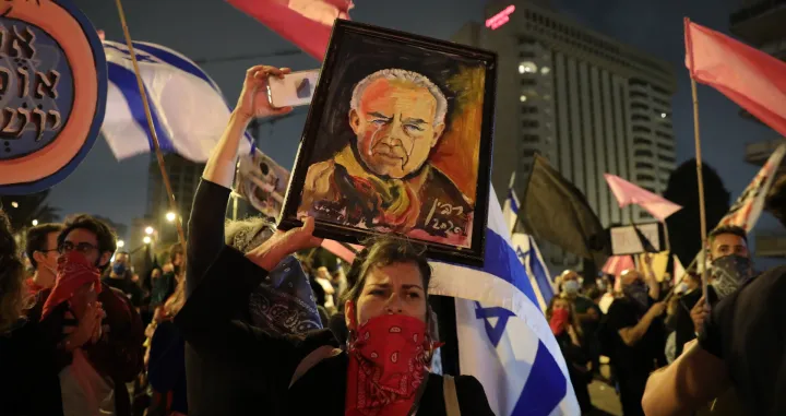 epa08789916 Anti-Netanyahu protesters hold a painting of late Israeli PM, Yitzhak Rabin during a protest against Israeli Prime Minister Benjamin Netanyahu outside his residence, in Jerusalem, 31 October 2020. Netanyahu faces an ongoing trial with indictments filed against him by the State Attorney's Office on charges of fraud, bribery and breach of trust. EPA/ABIR SULTAN/Abir Sultan