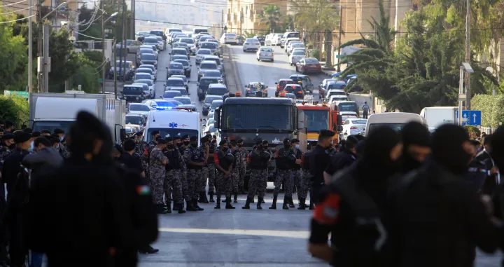 epa09191993 Security members stand guard as Jordanians demonstrate to express solidarity with the Palestinian people, near the Israeli embassy in Amman, Jordan, 11 May 2021. In response to days of violent confrontations between Israeli security forces and Palestinians in Jerusalem, various Palestinian militants factions in Gaza launched rocket attacks that killed two Israelis in the city of Ashkelon. Israel Defense Forces (IDF) said they hit over 100 targets in Gaza Strip during retaliatory overnight strikes. The Health Ministry of Gaza strip said that at least 26 Palestinian, including nine children, were killed from the Israeli airstrikes. Israeli Prime Minister Benjamin Netanyahu said on 11 May that they will increase the rate and intensity of the strikes. EPA/MOHAMMAD ALI/Mohammad Ali