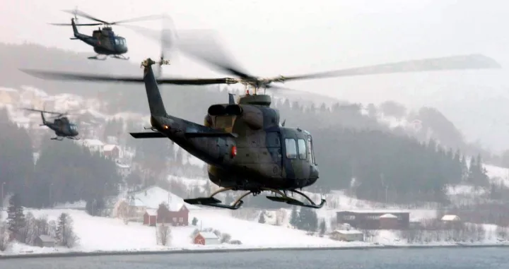 LUNDAMO, Norway -- A group of Norwegian Bell 412SP's travel to the port of Orkanger to insert a team of Marines from 1st Battalion, 8th Marine Regiment. The leathernecks are participating in DV (distinguished visitors) Day March 10 during Battle Griffin, the second phase of NATO exercise Strong Resolve '02. (USMC photo by Cpl. Paula M. Fitzgerald)/