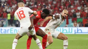 epa10342030 Alphonso Davies (C) of Canada in action against Sofyan Amrabat (R) of Morocco during the FIFA World Cup 2022 group F soccer match between Canada and Morocco at Al Thumama Stadium in Doha, Qatar, 01 December 2022. EPA/Mohamed Messara