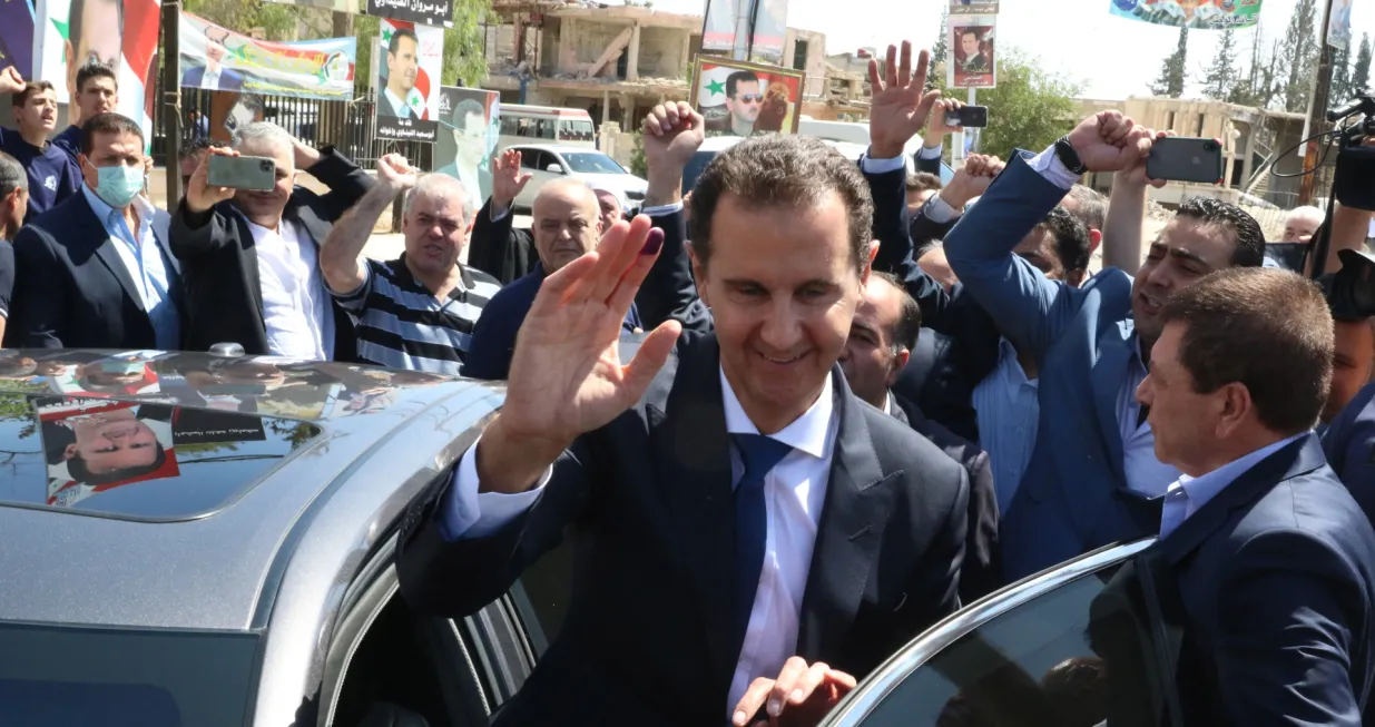 epa09623541 Syrian President Bashar al-Assad waves at supporters as he leaves a polling station in Duma city, Syria, 26 May 2021. The city was liberated by the Syrian army in 2018 after driving rebels out. Syrians will choose one out of three candidates, including Assad, for the post of President of the Syrian Arab Republic. The number of eligible voters registered inside and outside Syria has reached more than 18 million. EPA/YOUSSEF BADAWI/Youssef Badawi