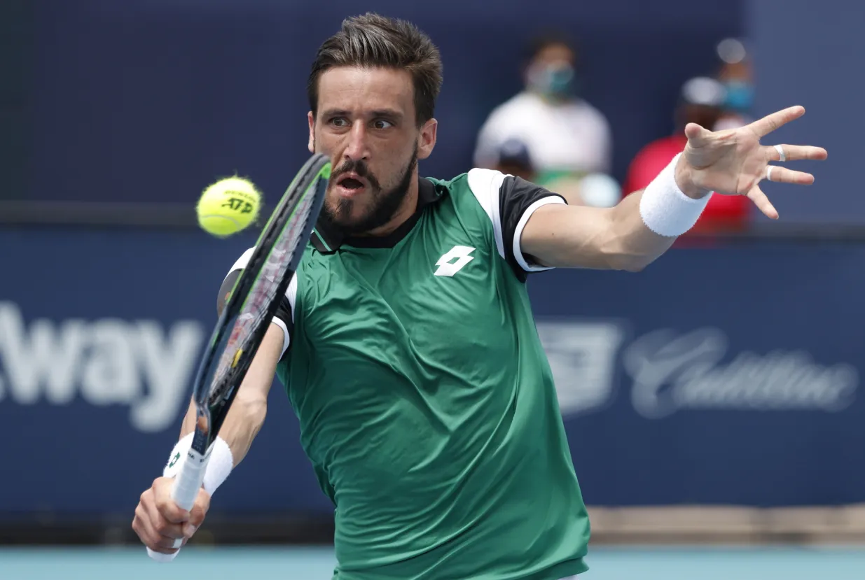 epa09102167 Damir Dzumhur of Bosnia in action against Stefanos Tsitsipas of Greece during their Men's singles match at the Miami Open tennis tournament in Miami Gardens, Florida, USA, 27 March 2021. EPA/RHONA WISE/Rhona Wise