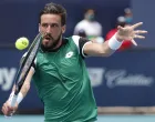 epa09102167 Damir Dzumhur of Bosnia in action against Stefanos Tsitsipas of Greece during their Men's singles match at the Miami Open tennis tournament in Miami Gardens, Florida, USA, 27 March 2021. EPA/RHONA WISE