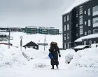 epa09112194 Woman walks the snow-covered street in Nuuk, Greenland, 02 April 2021. The Danish autonomous territory Greenland will hold parliamentary elections on 06 April 2021. EPA/EMIL HELMS DENMARK OUT/Emil Helms