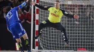 epa09838714 France' Ludovic Fabregas (L) in action against Denmark's goalkeeper Emil Nielsen during the Golden League men's handball match between Denmark and France, in Aarhus, Denmark, 20 March 2022. EPA/Mikkel Berg Pedersen DENMARK OUT