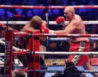 epa10347240 British boxer Tyson Fury (R) in action against British boxer Derek Chisora (L)during the bout between WBC heavyweight champion Tyson Fury and Derek Chisora at the Tottenham Hotspur stadium in London, Britain, 03 December 2022. EPA/TOLGA AKMEN