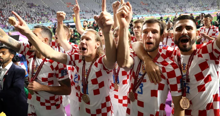 epa10370608 (from R) Martin Erlic, Borna Barisic, Domagoj Vida and Dejan Lovren of Croatia celebrate after the team won the FIFA World Cup 2022 third place soccer match between Croatia and Morocco at Khalifa International Stadium in Doha, Qatar, 17 December 2022. EPA/Tolga Bozoglu