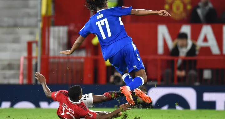 epa10393165 Manchester United's Tyrell Malacia (down) in action against Everton's Alex Iwobi (R)during the FA Cup third round match between Manchester United and Everton in Manchester, Britain, 06 January 2023. EPA/Peter Powell EDITORIAL USE ONLY. No use with unauthorized audio, video, data, fixture lists, club/league logos or 'live' services. Online in-match use limited to 120 images, no video emulation. No use in betting, games or single club/league/player publications