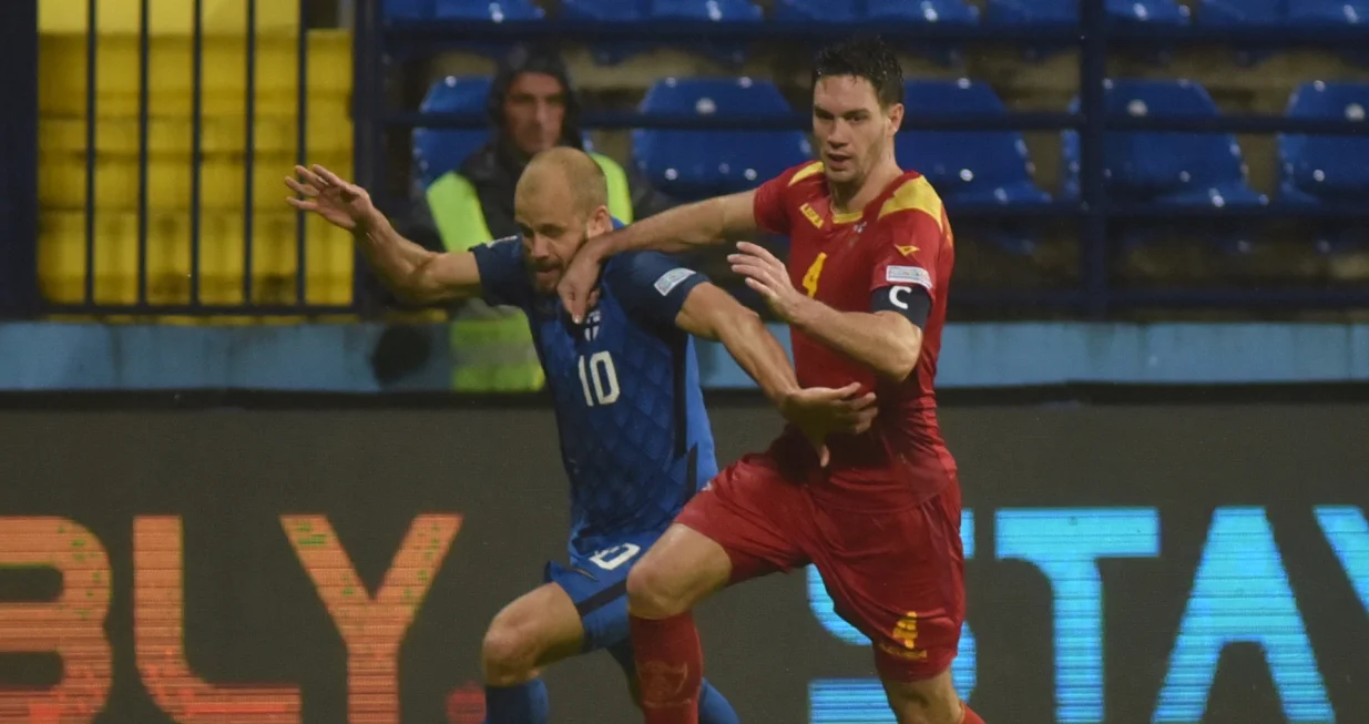 epa10208344 Finland's Teemu Pukki (L) in action against Montenegro's Nikola Vukcevic (R) during the UEFA Nations League soccer match between Montenegro and Finland in Podgorica, Montenegro, 26 September 2022. EPA/BORIS PEJOVIC