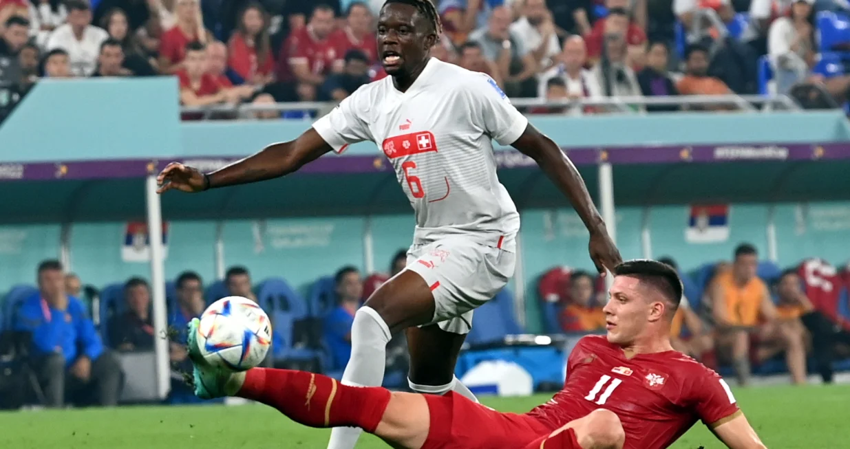 epa10345267 Luka Jovic (R) of Serbia in action against Denis Zakaria of Switzerland during the FIFA World Cup 2022 group G soccer match between Serbia and Switzerland at Stadium 947 in Doha, Qatar, 02 December 2022. EPA/Georgi Licovski