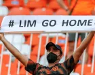 epa09205417 A Valencia's supporter holds a placard that reads 'Lim Go Home' demanding Valencia's owner Peter Lim to leave the club during the Spanish LaLiga soccer match between Valencia CF and SD Eibar held at Mestalla stadium in Valencia, eastern Spain, 16 May 2021. EPA/Biel Alino