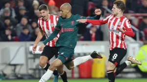 epa10386657 Fabinho of Liverpool (C) in action against Vitaly Janelt (L) and Mathias Jensen (R) of Brentford during the English Premier League soccer match between Brentford FC and Liverpool FC in Brentford, Britain, 02 January 2023. EPA/Kieran Galvin EDITORIAL USE ONLY. No use with unauthorized audio, video, data, fixture lists, club/league logos or 'live' services. Online in-match use limited to 120 images, no video emulation. No use in betting, games or single club/league/player publications