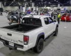 epa09142257 A boy jumps from the bed of a 2021 Toyota Tacoma pickup truck on display during the Atlanta International Auto Show at the Georgia World Congress Center in Atlanta, Georgia, USA, 17 April 2021. The show, whose roots date back to 1909, is one of the few in-person auto shows in operation due to the COVID-19 coronavirus pandemic. EPA/ERIK S. LESSER/Erik S. Lesser