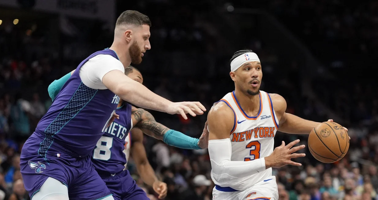 Mar 20, 2025; Charlotte, North Carolina, USA; New York Knicks guard Josh Hart (3) passes off under pressure from Charlotte Hornets center Jusuf Nurkic (11) during the first quarter at Spectrum Center. Mandatory Credit: Jim Dedmon-Imagn Images