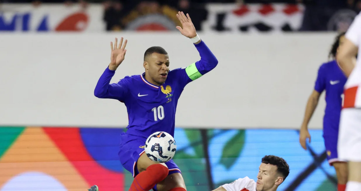 Soccer Football - Nations League - Quarter Final - First Leg - Croatia v France - Stadion Poljud, Split, Croatia - March 20, 2025 France's Kylian Mbappe in action with Croatia's Ivan Perisic REUTERS/Antonio Bronic
