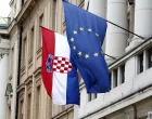 epa09960504 The flags of Croatia (L) and European Union (EU) hang from the facade of the Parliament building at old town in Zagreb, Croatia, 20 May 2022. Croatia, which joined the EU in 2013, is set to join the Eurozone in January 2023, with the introduction of the euro as the country's official currency after Croatian lawmakers voted in favor of legislation to bring the shared currency. EPA/ANTONIO BAT/Antonio Bat