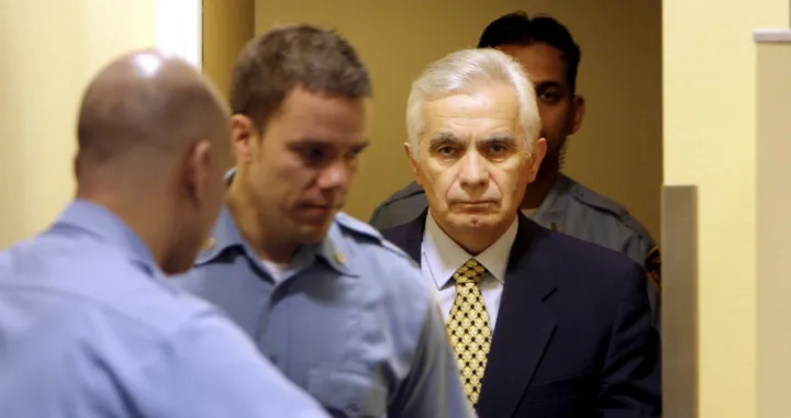 epa08669665 (FILE) - The former speaker of the Bosnian Serb parliament Momcilo Krajisnik (R) enters the courtroom for his appeals verdict at the courtroom of the U.N. Yugoslav war crimes tribunal in the Hague, Netherlands, 17 March 2009 (reissued 15 September 2020). University Clinical Centre in Banja Luka, Bosnia Herzegovina said 15 September 2020 Momcilo Krajisnik, a Bosnian Serb political leader, has died of infection with the novel coronavirus at the clinic in Banja Luka, Bosnia Herzegovina. Krajisnik was found guilty in 2006 of committing crimes against humanity during the Bosnian War by the International Criminal Tribunal for the former Yugoslavia (ICTY) and was sentenced to 20 years' imprisonment. He was 01 September 2013 granted early release after serving two thirds of the sentence. EPA/BAS CZERWINSKI/POOL/Bas Czerwinski/Pool