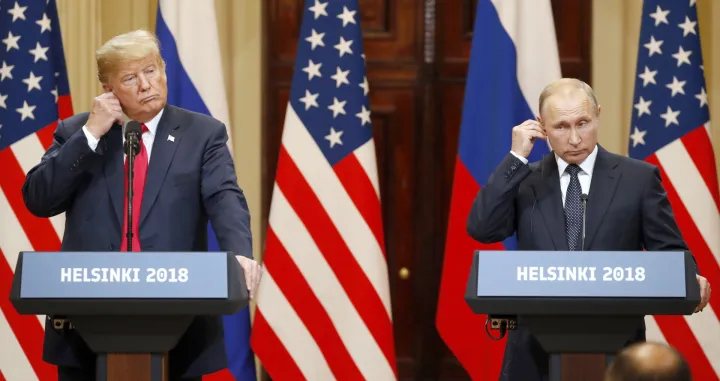 epa08939637 (FILE) US President Donald J. Trump (L) and Russian President Vladimir Putin (R) adjust their earpiece plugs during a joint press conference following their summit talks at the Presidential Palace in Helsinki, Finland, 16 July 2018. The presidency of Donald Trump, which records two presidential impeachments, will end at noon on 20 January 2021. EPA/ANATOLY MALTSEV/Anatoly Maltsev