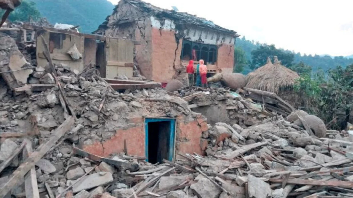 People stand outside the ruins of collapsed houses after an earthquake struck early Wednesday, in the western district of Doti, Nepal November 9, 2022. Nepal Army/Handout via REUTERS THIS IMAGE HAS BEEN SUPPLIED BY A THIRD PARTY. NO RESALES. NO ARCHIVES/Nepal Army