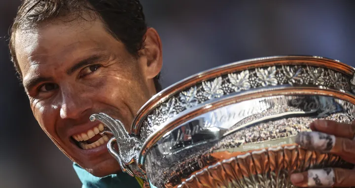 epa09997875 Rafael Nadal of Spain poses with the trophy La Coupe des Mousquetaires after winning against Casper Ruud of Norway in their Men's Singles final match during the French Open tennis tournament at Roland ​Garros in Paris, France, 05 June 2022. EPA/MARTIN DIVISEK