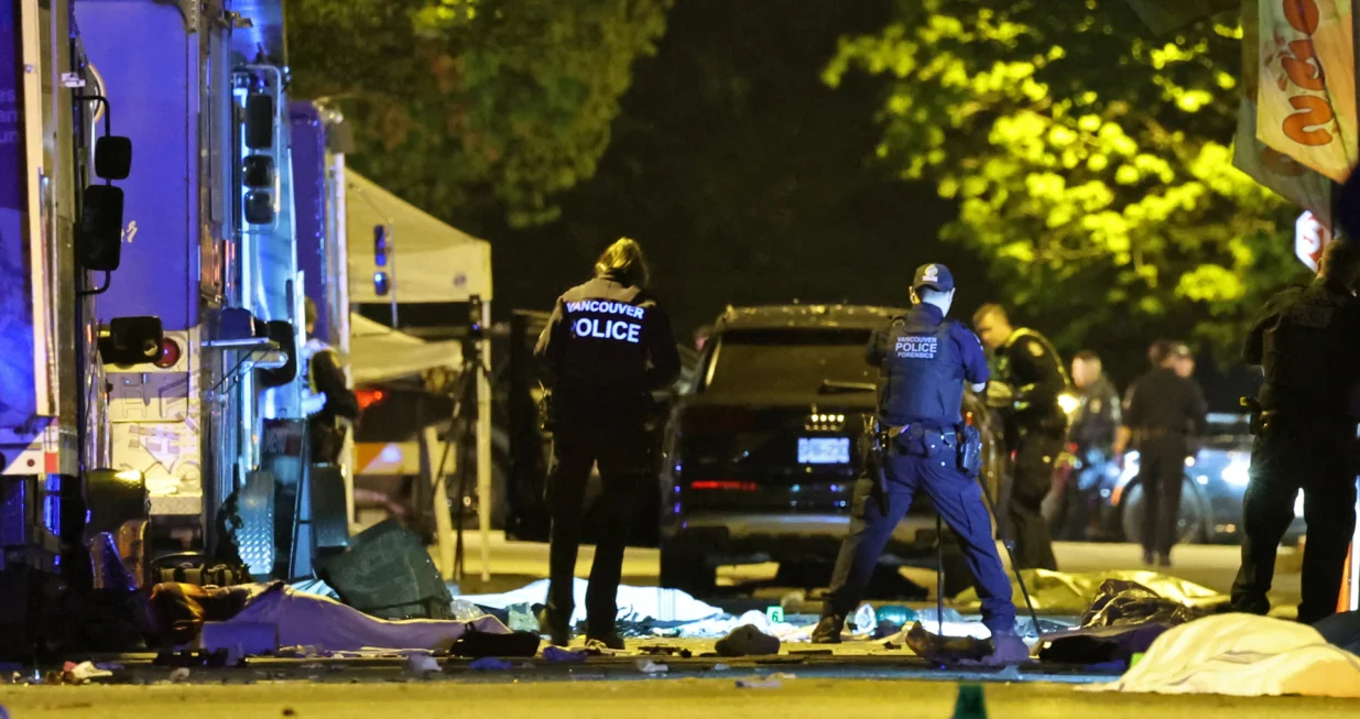 Vancouver Police forensics officers investigate the scene of a suspect vehicle and bodies of victims lying covered on the ground, after it drove into a crowd at a Lapu Lapu day block party, in which police say multiple people were killed and injured, in Vancouver, Canada April 27, 2025. REUTERS/Chris Helgren/Chris Helgren