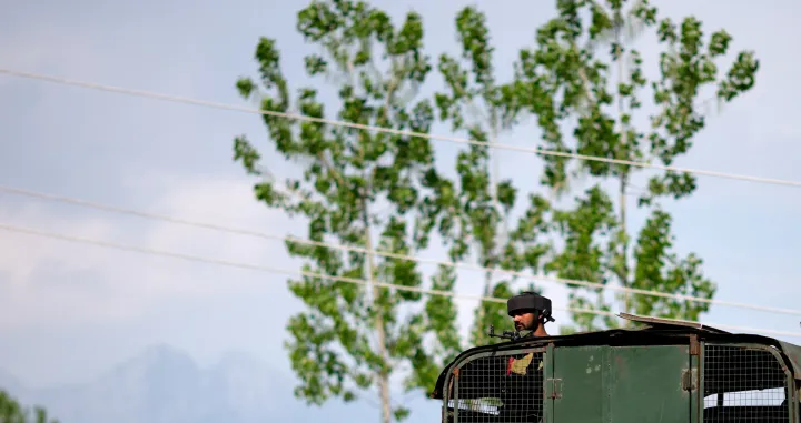 An Indian Army soldier looks out from an armoured vehicle on a highway leading to South Kashmir's Pahalgam, following a suspected militant attack, in Marhama village, in Kashmir, April 23, 2025. REUTERS/Adnan Abidi  TPX IMAGES OF THE DAY/Adnan Abidi