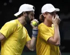 epa10328657 Australia's Jordan Thompson (L) and Max Purcell (R) in action against Croatia's Nikola Mektic and Mate Pavic during their match in the Davis Cup semi final between Croatia and Australia in Malaga, Spain, 25 November 2022. EPA/Jorge Zapata