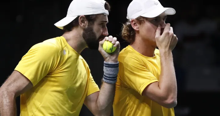 epa10328657 Australia's Jordan Thompson (L) and Max Purcell (R) in action against Croatia's Nikola Mektic and Mate Pavic during their match in the Davis Cup semi final between Croatia and Australia in Malaga, Spain, 25 November 2022. EPA/Jorge Zapata