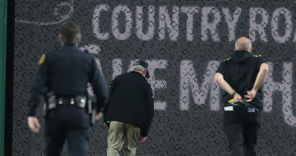 Apr 30, 2025; Pittsburgh, Pennsylvania, USA; Stadium security and Pittsburgh Pirates medical personnel rush to assist a fan who fell from the stands to the field as the Pirates batted against the Chicago Cubs during the seventh inning at PNC Park. Mandatory Credit: Charles LeClaire-Imagn Images