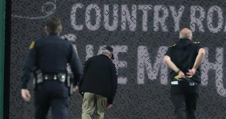Apr 30, 2025; Pittsburgh, Pennsylvania, USA; Stadium security and Pittsburgh Pirates medical personnel rush to assist a fan who fell from the stands to the field as the Pirates batted against the Chicago Cubs during the seventh inning at PNC Park. Mandatory Credit: Charles LeClaire-Imagn Images