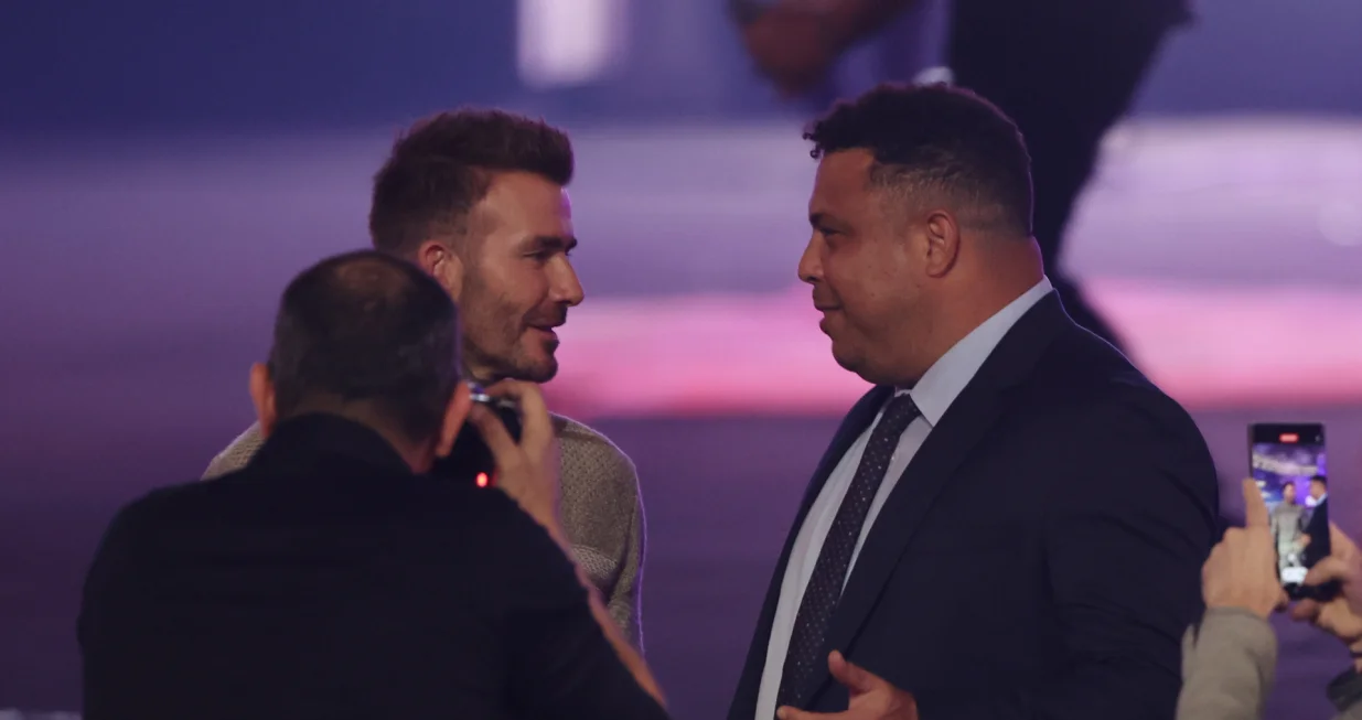 epa10368868 Former English international David Beckham (L) talks with his former Real Madrid teammate, former Brazilian international and 2002 World Cup winner Ronaldo (R) during the Qatar Fashion United by CR Runway fashion show at the 974 Stadium in Doha, Qatar, 16 December 2022. EPA/MARTIN DIVISEK