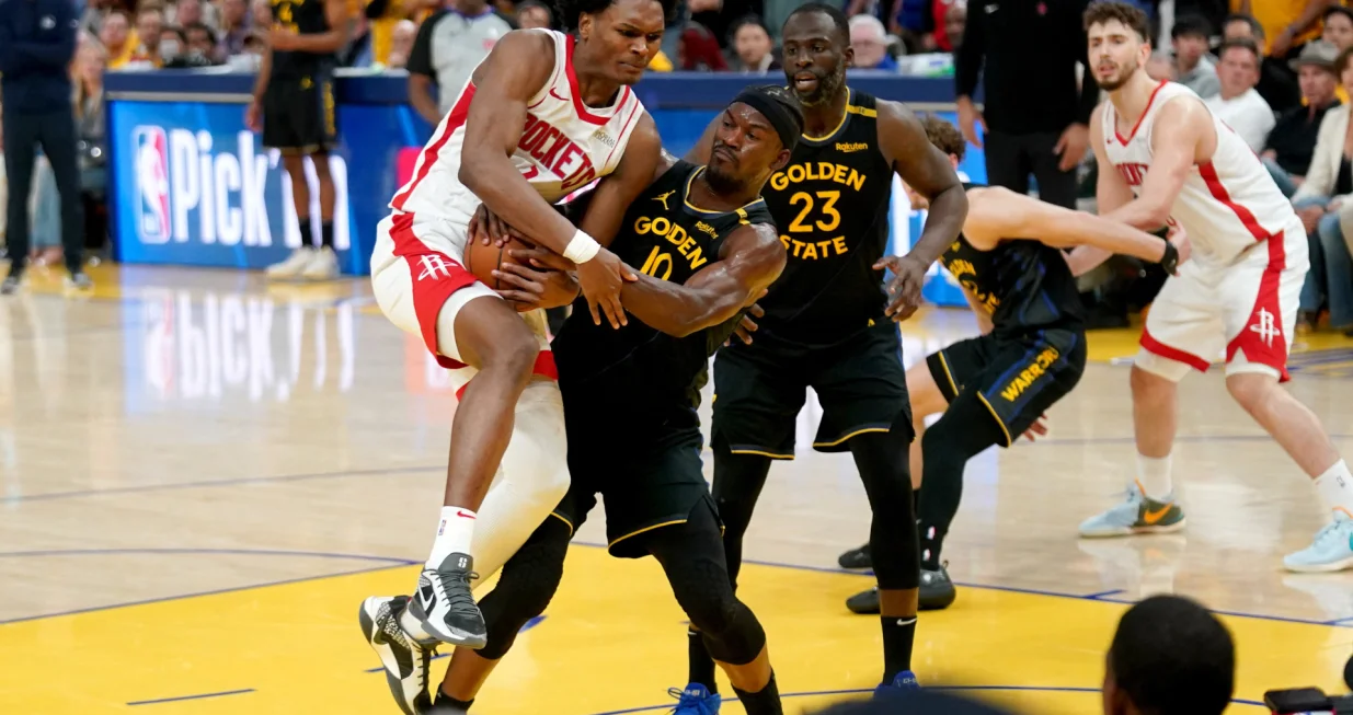 May 2, 2025; San Francisco, California, USA; Golden State Warriors forward Jimmy Butler III (10) forces a jump ball while defending Houston Rockets forward Amen Thompson (1) in the fourth quarter of game six of the first round for the 2025 NBA Playoffs at Chase Center. Mandatory Credit: Cary Edmondson-Imagn Images